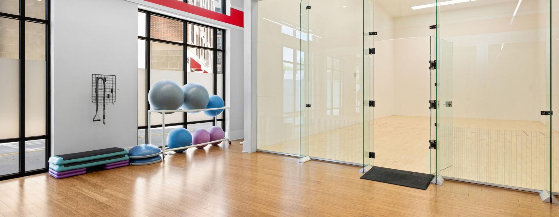 a room with a wood floor and glass doors