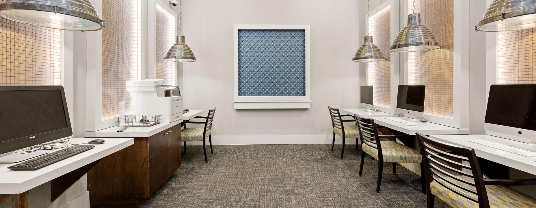 a room with a desk and computers